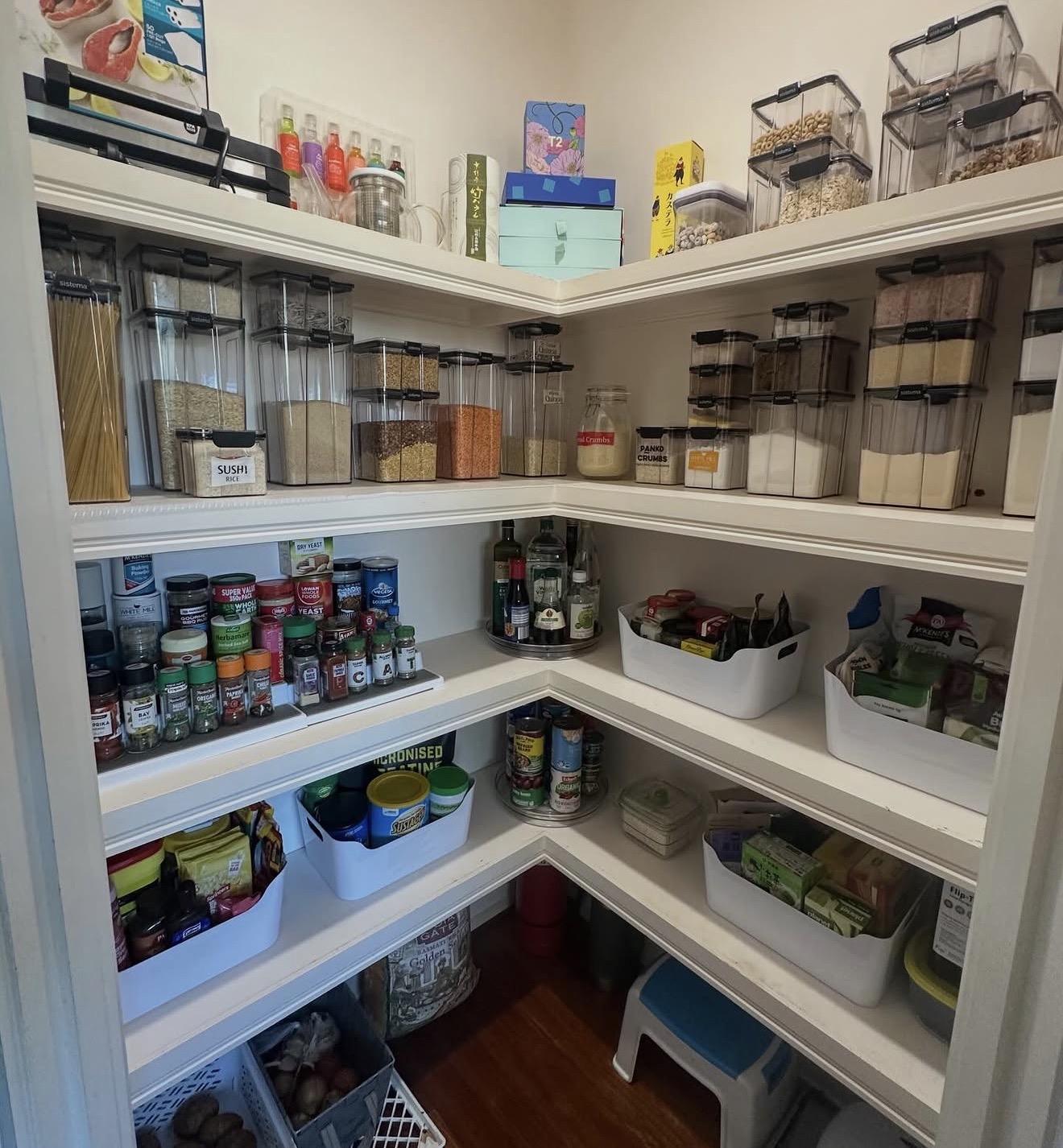 Organised walk-in pantry with labelled containers and practical zones